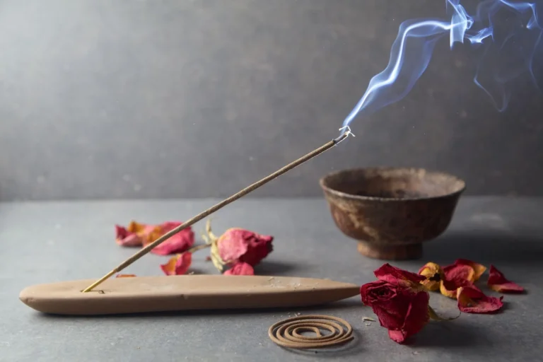 Burning incense stick with rose petals